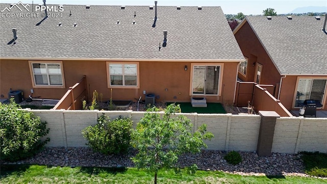 rear view of property with central air condition unit