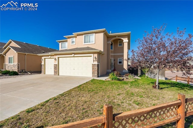 front facade featuring a front yard and a garage