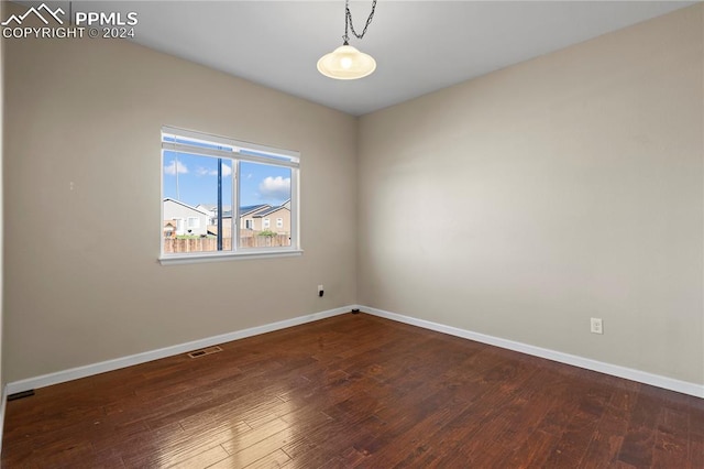 unfurnished room featuring dark wood-type flooring