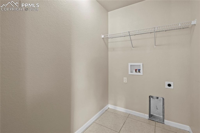 clothes washing area featuring light tile patterned floors, hookup for an electric dryer, and washer hookup