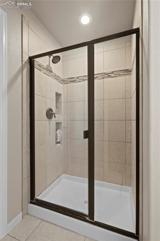 bathroom with tile patterned flooring and an enclosed shower