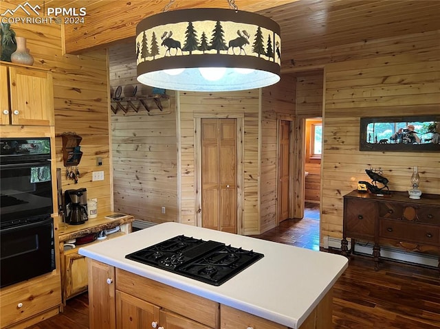 kitchen with dark wood-type flooring, hanging light fixtures, a kitchen island, wooden walls, and black appliances