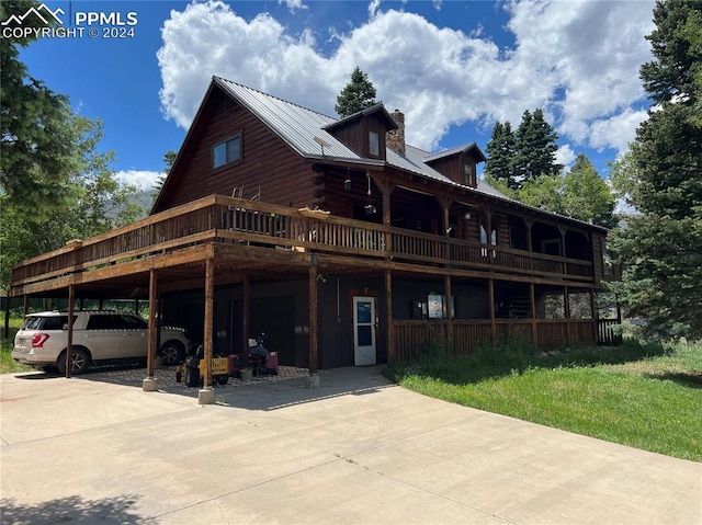 back of property with a lawn and a deck