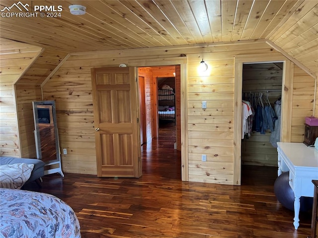 bedroom with wood ceiling, wood walls, vaulted ceiling, and dark hardwood / wood-style floors