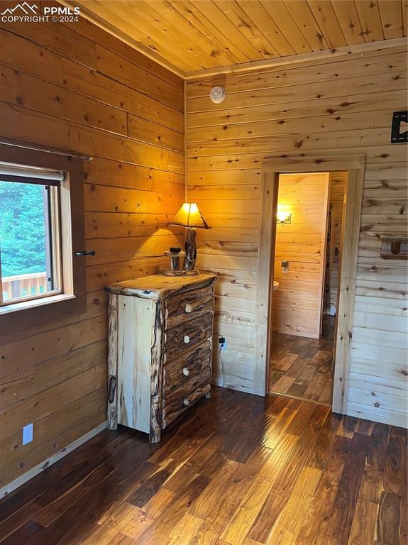 unfurnished bedroom with wood ceiling, wood walls, and dark hardwood / wood-style flooring