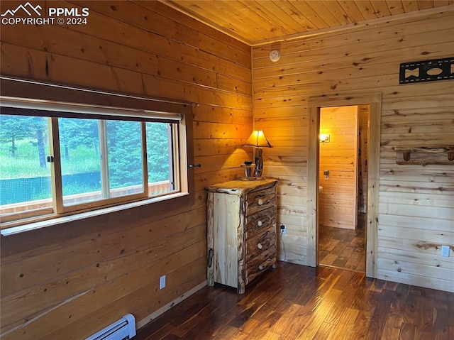 unfurnished bedroom with wood walls and dark hardwood / wood-style flooring