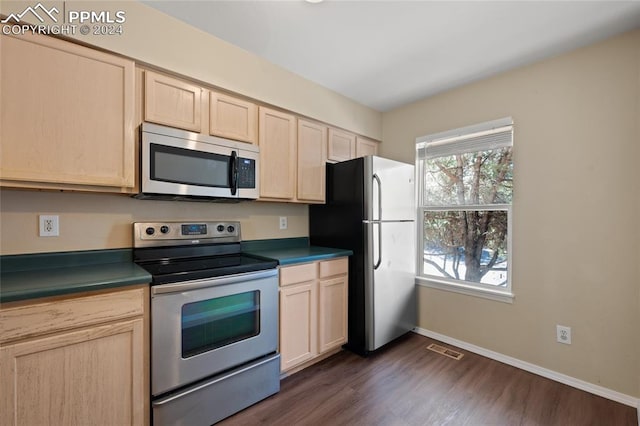 kitchen featuring dark hardwood / wood-style floors, light brown cabinets, and appliances with stainless steel finishes