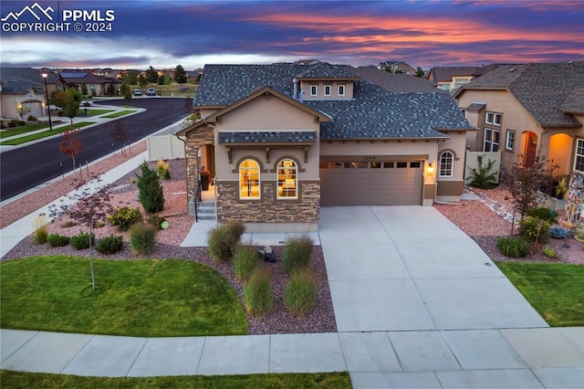 view of front of property featuring a yard and a garage