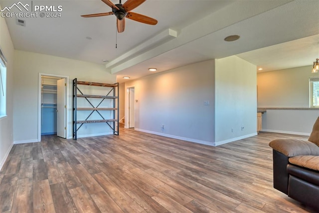 unfurnished living room with ceiling fan and hardwood / wood-style floors