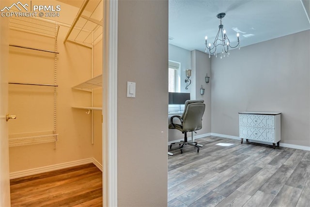 home office featuring a chandelier and hardwood / wood-style floors