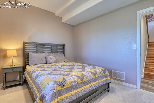 bedroom featuring light carpet