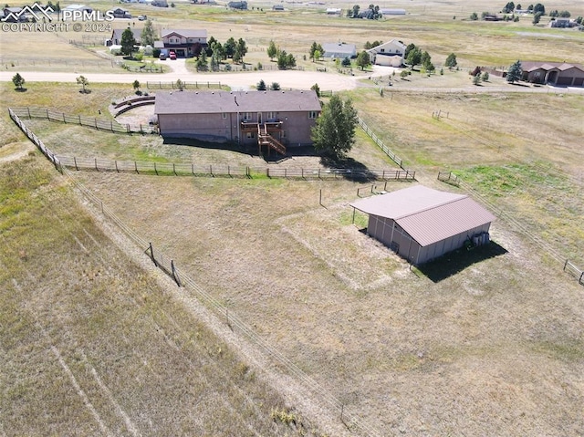 birds eye view of property featuring a rural view