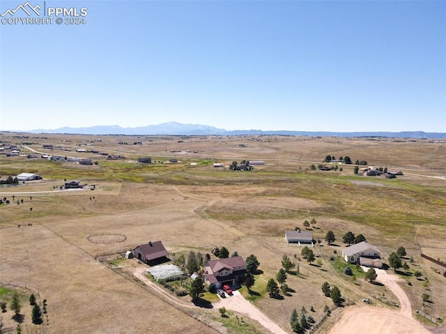 drone / aerial view with a mountain view and a rural view