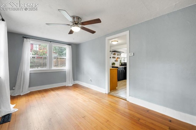 spare room featuring ceiling fan and light hardwood / wood-style flooring