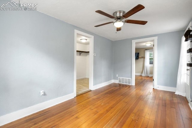 interior space featuring wood-type flooring and ceiling fan