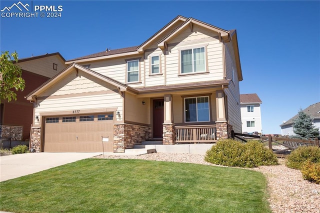 6777 Ironwood Tree Cir, Colorado Springs, CO 80927 - craftsman-style home featuring a front lawn, fence, stone siding, a porch, and driveway