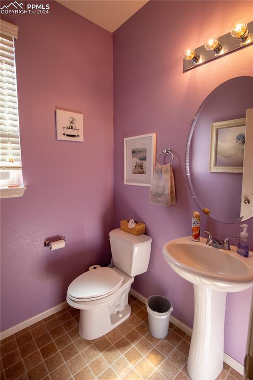 6777 Ironwood Tree Cir, Colorado Springs, CO 80927 - half bathroom with baseboards, tile patterned flooring, and toilet