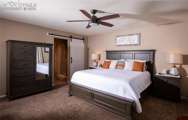 6777 Ironwood Tree Cir, Colorado Springs, CO 80927 - bedroom featuring dark carpet, a barn door, and ceiling fan
