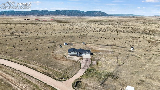 birds eye view of property featuring a mountain view and a rural view