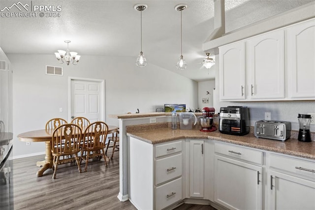 kitchen featuring lofted ceiling, white cabinetry, and hardwood / wood-style flooring