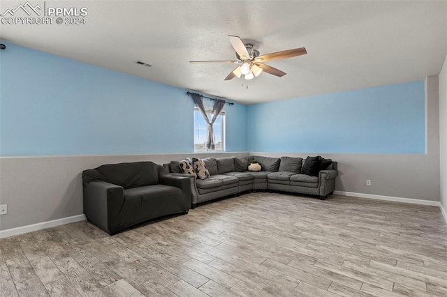 living room with ceiling fan and light hardwood / wood-style floors