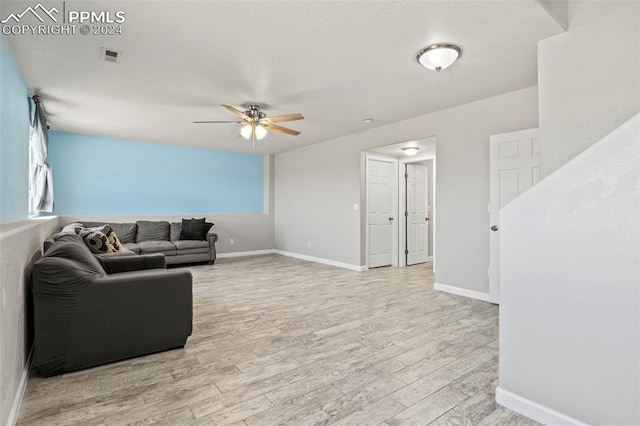 living room with ceiling fan and light wood-type flooring