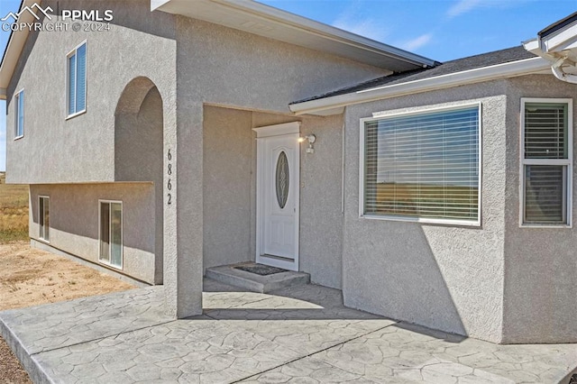 doorway to property featuring a patio area