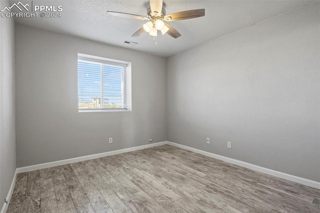 spare room with ceiling fan and hardwood / wood-style flooring