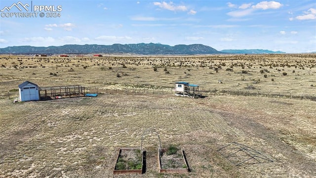 birds eye view of property featuring a mountain view and a rural view