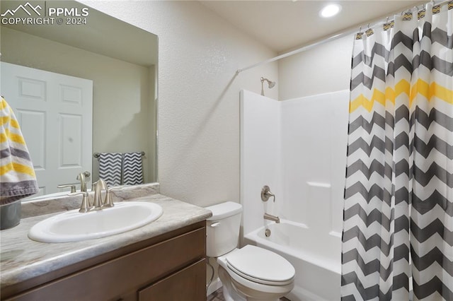 full bathroom featuring vanity, shower / tub combo, and toilet