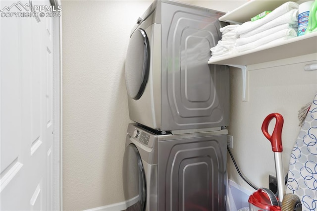 laundry area with stacked washer and dryer