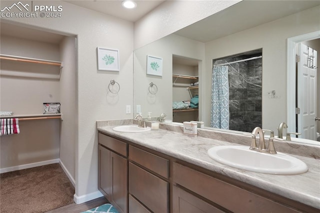 bathroom featuring vanity and curtained shower