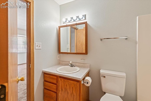 bathroom featuring vanity and toilet