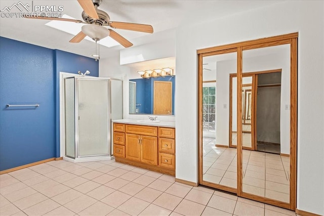 bathroom featuring walk in shower, vanity, ceiling fan, and tile patterned floors