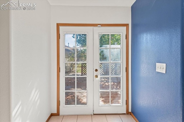 doorway to outside featuring french doors and light tile patterned floors