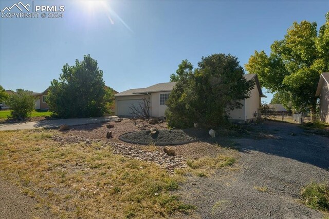 obstructed view of property with a garage