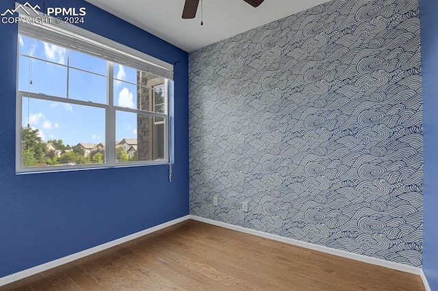 spare room with ceiling fan and hardwood / wood-style floors