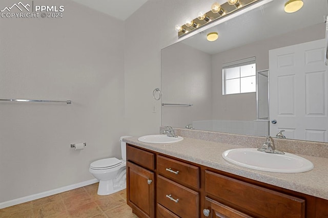 bathroom with tile patterned flooring, vanity, and toilet