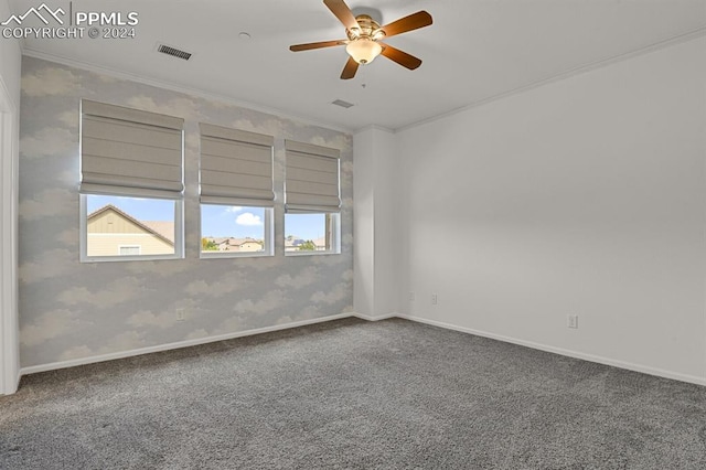 carpeted empty room featuring ceiling fan and ornamental molding