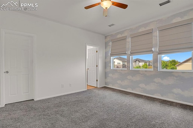 carpeted empty room featuring ceiling fan and crown molding