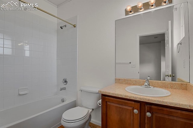 full bathroom featuring vanity, tiled shower / bath combo, and toilet