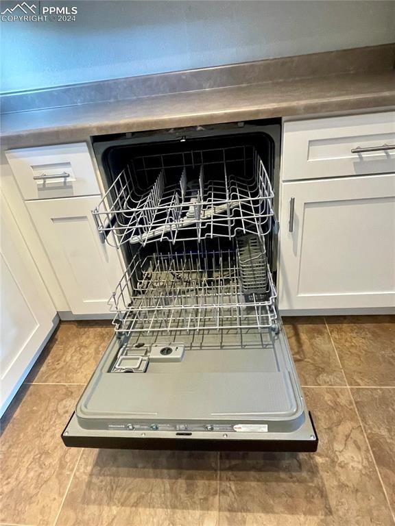 room details featuring white cabinetry and dishwasher