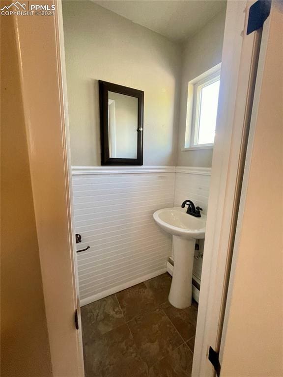 bathroom with tile walls and sink