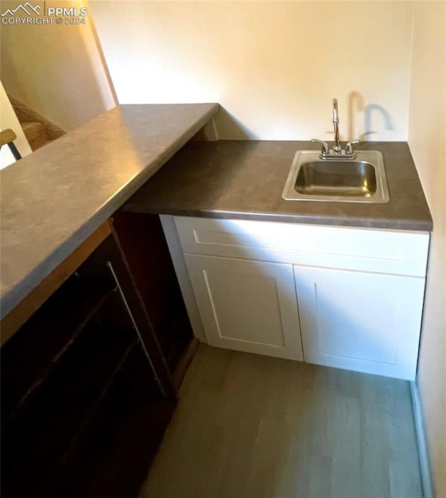 kitchen featuring white cabinets and sink