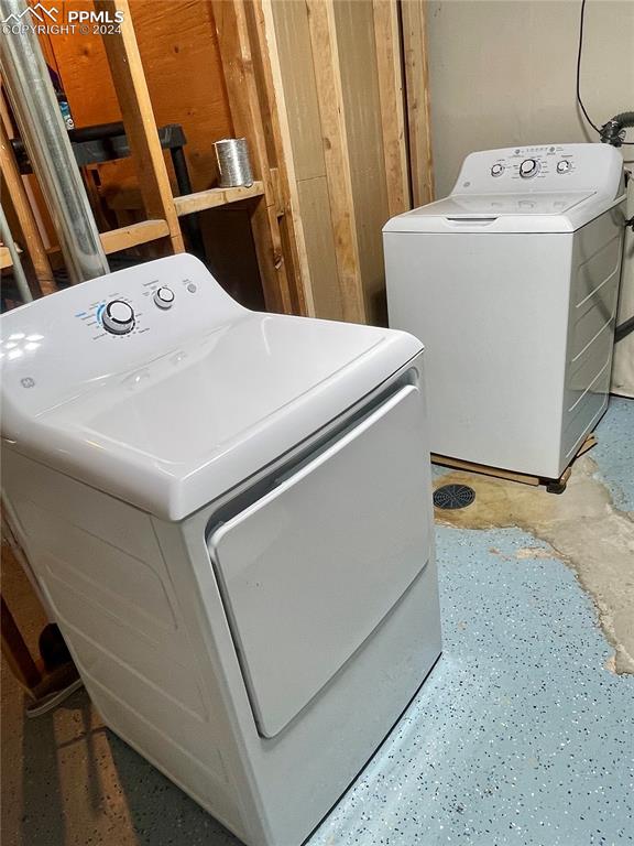 clothes washing area with separate washer and dryer