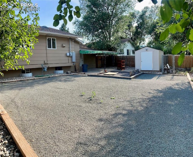 exterior space featuring a shed and a patio area