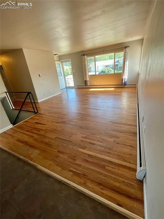 spare room with hardwood / wood-style flooring and a wealth of natural light