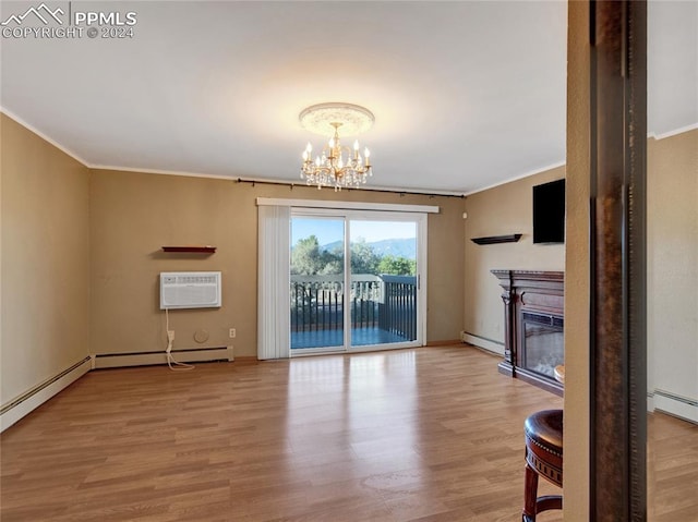 unfurnished living room featuring a wall unit AC, hardwood / wood-style flooring, a notable chandelier, baseboard heating, and ornamental molding