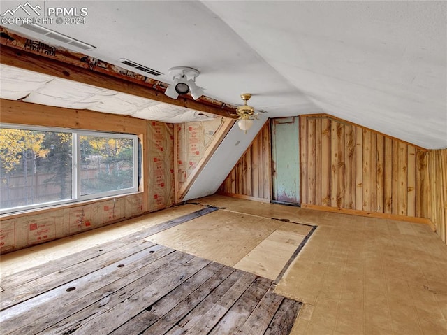 additional living space featuring lofted ceiling and ceiling fan