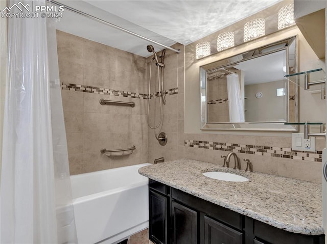 bathroom with vanity, tile walls, shower / bathtub combination with curtain, and decorative backsplash